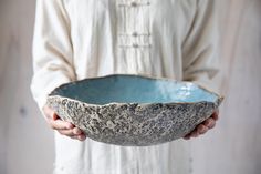 a person holding a bowl in their hands