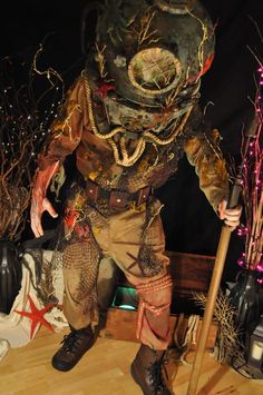 a man dressed as a scarecrow holding a stick