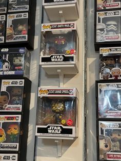 some star wars action figures are on display in a store shelf with other toys and collectibles