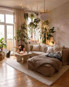 a living room filled with furniture and lots of plants