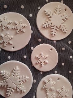 four snowflakes are sitting on top of a baking sheet with white icing