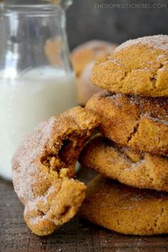 a stack of cookies next to a glass of milk