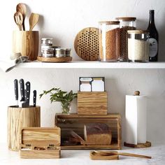 kitchen utensils and cutting boards are on the shelves next to eachother