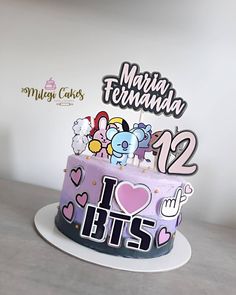 there is a cake that has been decorated with cartoon characters on it and the number twelve