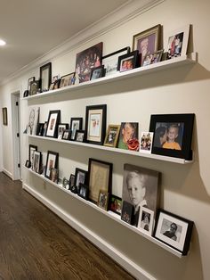 the wall is filled with pictures and framed photographs