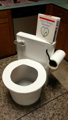 a toilet with a book on the lid