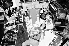 a man laying on the floor surrounded by musical instruments