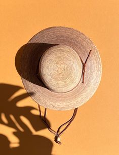 A sustainable and practical essential for warm sunny days, the Nelly hat is handmade from ethically grown palm leaves. With a sturdy brim and an open lattice design circling the top (allowing for ventilation during those humid summer months), this sun hat is the perfect finishing touch with jeans and a tee or pair it with your favorite sundress for a day in the park. Hand woven palm Fair Trade 100% natural palm leaf, grown in Mexico UPF50+ Water resistant Approx 3 1/2" brim Grosgrain inner band Adjustable Woven Toquilla Straw Boater Hat, Adjustable Woven Boater Hat In Toquilla Straw, Natural Handwoven Boater Hat With Curved Brim, Handwoven Adjustable Boater Hat With Flat Brim, Adjustable Handwoven Boater Hat With Flat Brim, Bohemian Palm Leaf Boater Hat With Short Brim, Woven Palm Leaf Boater Hat With Wide Brim, Adjustable Summer Boater Hat In Natural Color, Bohemian Natural Boater Hat For Warm Weather