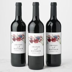 three bottles of wine with thank you labels on the front and back one is red