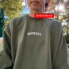 "*SIZES ARE UNISEX* -I'd suggest your usual size for a regular fit, or sizing up for a more relaxed fit. *these sweatshirts are extra comfy when oversized \"Midwest\" embroidered on a cute vintage-style crewneck. A cozy sweatshirt bound to keep you warm in the colder months. A pre-shrunk, classic fit sweater that's made with air-jet spun yarn for a soft feel and reduced pilling. Your new favorite sweatshirt! * 50% cotton, 50% polyester * Pre-shrunk * Classic fit with no center crease * 1x1 athle Casual Sweatshirt With Embroidered Graphics, Relaxed Fit Embroidered Sweatshirt For Everyday, Fall Streetwear Sweatshirt With Embroidered Text, Casual College Sweatshirt With Embroidered Text, Casual Sweater With Embroidered Graphics, Casual Sweater With Embroidered Graphics And Relaxed Fit, Casual Sweater With Embroidered Graphics In Relaxed Fit, Oversized Sweater With Embroidered Logo For Fall, Oversized Fall Sweater With Embroidered Logo