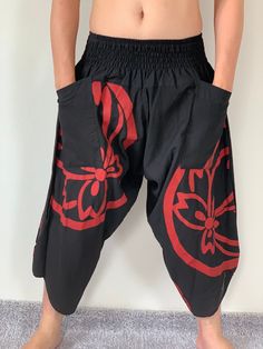 "Samurai Pants, elastic waist Samurai Pants Unisex Elastic Waist, ninja pants Samurai Pants (Unisex) Elastic Waist MATERIAL: 100% Cotton APPROX MEASUREMENT: Elastic Waist :24\"- 40\" Length :34\" Hip up to :52\" Around Ankle: 18 inch Pockets: x 2 Material : Cotton ♥ PAYMENT We accept payments via PayPal only. ♥ Shipping : - All items will be shipped within 1 business day after received payment. We ship items via DHL Express. ♥ Delivery Time : USA only 2 business days Canada: 2- 3 business days F Black Harem Pants With Pockets For Festival, Stretch Black Harem Pants For Festivals, Black Parachute Pants With Pockets For Festival, Black Harem Yoga Pants With Pockets, Traditional Black Harem Pants For Yoga, Black Cotton Harem Yoga Pants, Black Cotton Harem Pants For Yoga, Casual Black Harem Yoga Pants, Black Harem Pants With Elastic Waistband For Festivals