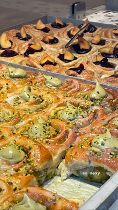 several trays filled with different types of pastries