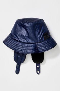 a blue leather hat with a black fur brim