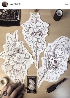 some stickers are on a table and someone is doing something with their hands to draw flowers