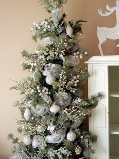 a decorated christmas tree with silver ornaments