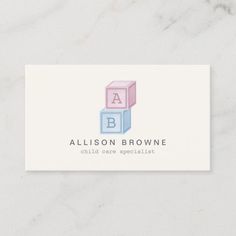 a white business card with a block logo on the front and blue blocks on the back