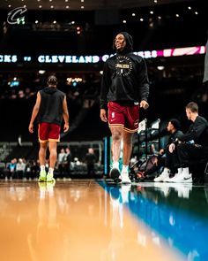 two basketball players are walking on the court