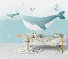 a baby's room with a whale wall mural