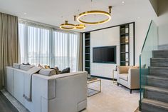 a living room filled with furniture and a flat screen tv on top of a wall