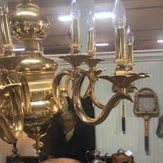 a large chandelier hanging from the ceiling in a room with other antique items