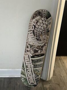 a snowboard leaning against the wall with money on it