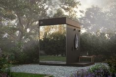 an outdoor shower in the middle of a garden with trees and flowers around it, next to a bench