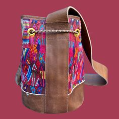 Score some style points with Intertwined's Small Huipil Bucket Bag! This dazzling piece is handcrafted with a vintage huipil (a traditional Mayan blouse) and vegetable-tanned leather. Its interior has a zip pocket and a slot pocket, perfect for stashing your phone, wallet, keys, and whatever else you need to bring along. And it's handmade by Guatemalan artisans at Cuero Malec. It's sure to get stares and questions from your pals - 'cause this bag is an absolute show-stealer! Leather Handwoven Shoulder Bag, Traditional Hand-stitched Bags For Everyday, Handwoven Multicolor Leather Bags, Artisan Handwoven Leather Bag, Multicolor Handwoven Leather Bags, Traditional Bucket Bag With Removable Pouch, Handwoven Multicolor Leather Shoulder Bag, Brown Handwoven Leather Hobo Bag, Multicolor Handwoven Leather Shoulder Bag