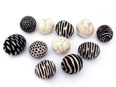 several black and white striped balls on a white background