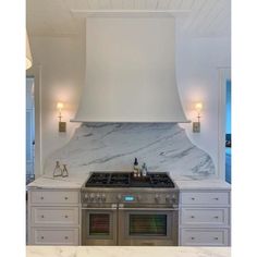 a stove top oven sitting inside of a kitchen next to a wall mounted range hood