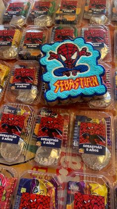 there are many spiderman cakes on the table