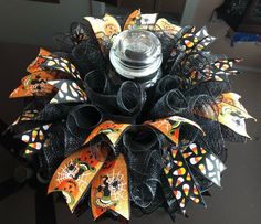 a halloween wreath made out of black mesh