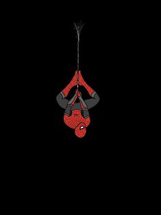 a spider man hanging upside down in the dark with his hands on his hipss