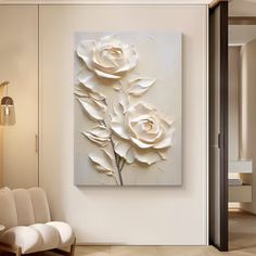 a large white flower painting hanging on the wall