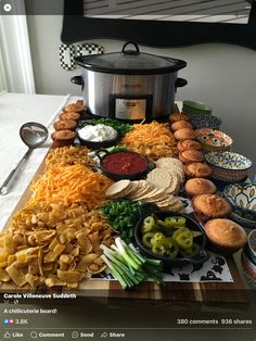 a table full of food including crackers, cheeses and other foods on it