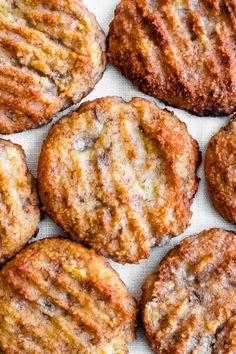 some cookies are sitting on a white tablecloth and ready to be eaten by someone