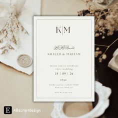 the wedding stationery is laid out on top of a table next to a wax stamp