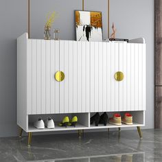 a white cabinet with shoes on it in a room