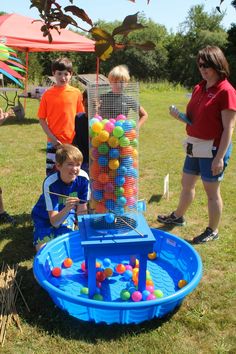 children playing with an inflatable ball pit