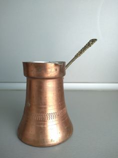 a metal cup with a toothbrush in it