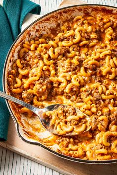 a casserole dish filled with ground beef and macaroni in a large skillet