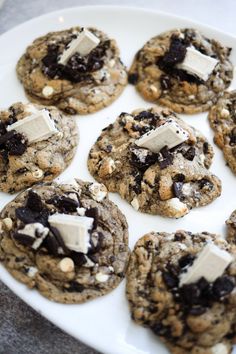 cookies with marshmallows and chocolate chips are arranged on a white platter