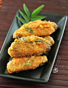 some fried food is on a black plate