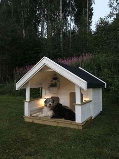 a dog is laying down in his house with lights on it's roof and head turned to look like he has fallen asleep