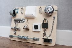 a wooden board with various items on it and a keychain attached to the wall