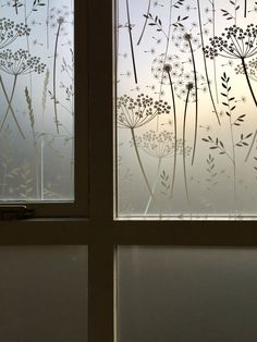 the window is covered in frosted glass and has dandelions on it's side