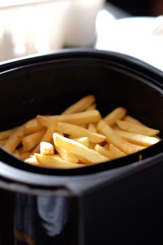 french fries are in an air fryer and ready to be cooked