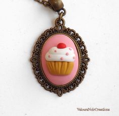 a necklace with a cupcake on it