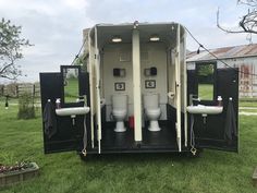 two toilets sitting in the back of a trailer