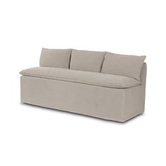 a beige couch sitting on top of a white floor