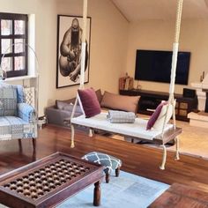 a living room filled with furniture and hanging chairs